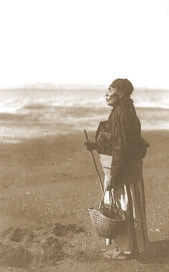 Chinook woman on the beach, Edward Curtis 1910; [Public domain image]